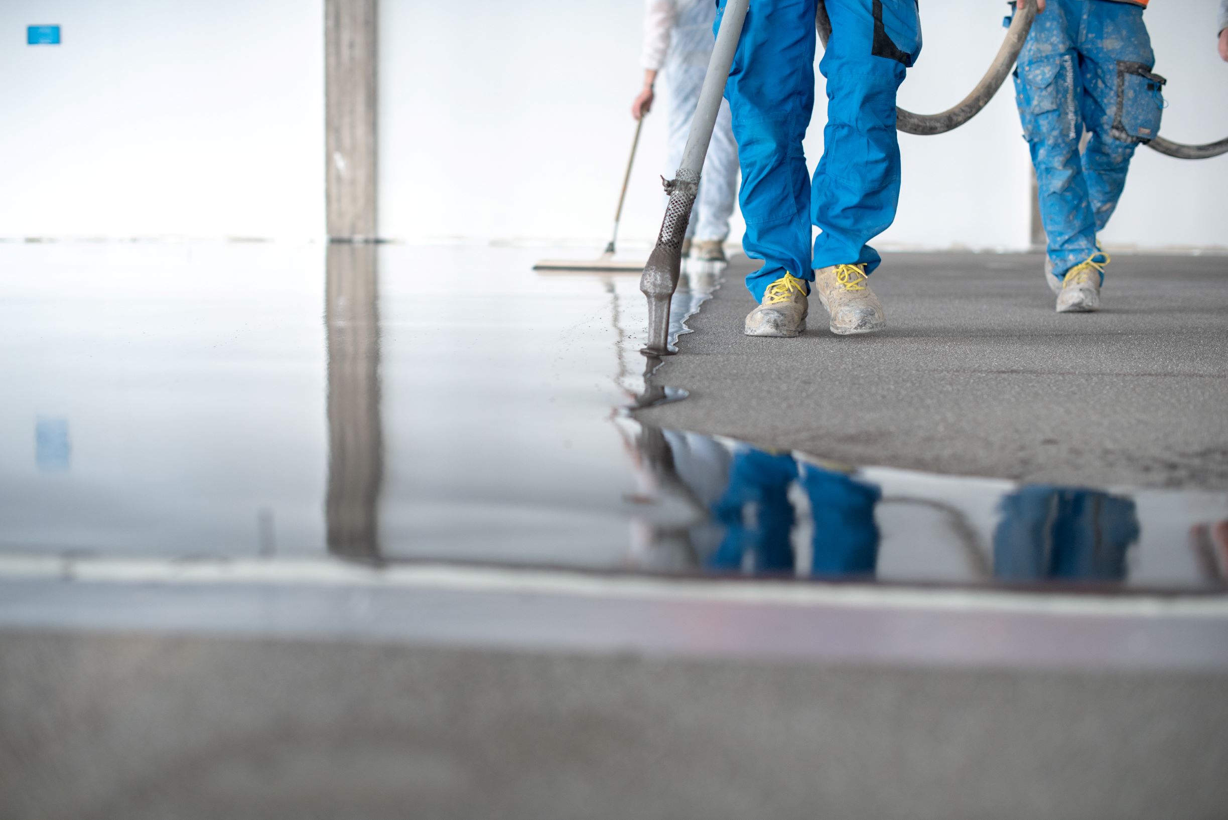construction workers leveling flooring in modern b 2026 03 16 04 29 26 utc