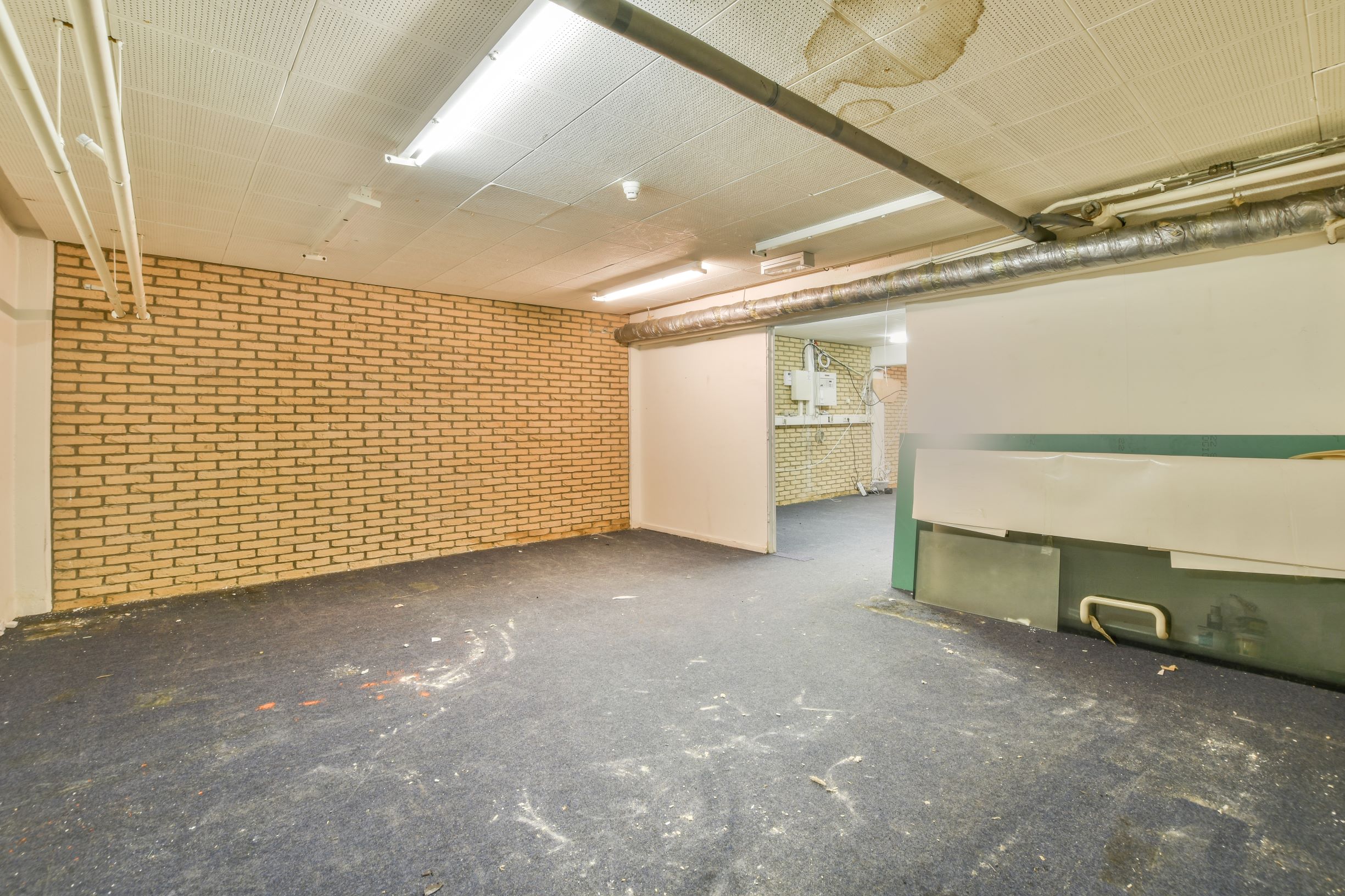 dilapidated empty room with brick wall and carpet 2026 01 07 23 22 01 utc